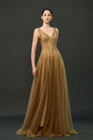 Caramel brown Samara gown by EEGEN STUDIO, elegant floor-length dress with flowing fabric and sophisticated design.