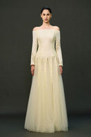 Off-white ELIRA gown by EEGEN STUDIO, elegant dress with flowing fabric and intricate detailing, perfect for formal occasions.