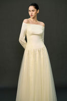 Off-white ELIRA gown by EEGEN STUDIO featuring elegant fabric and flowing design, perfect for formal occasions.