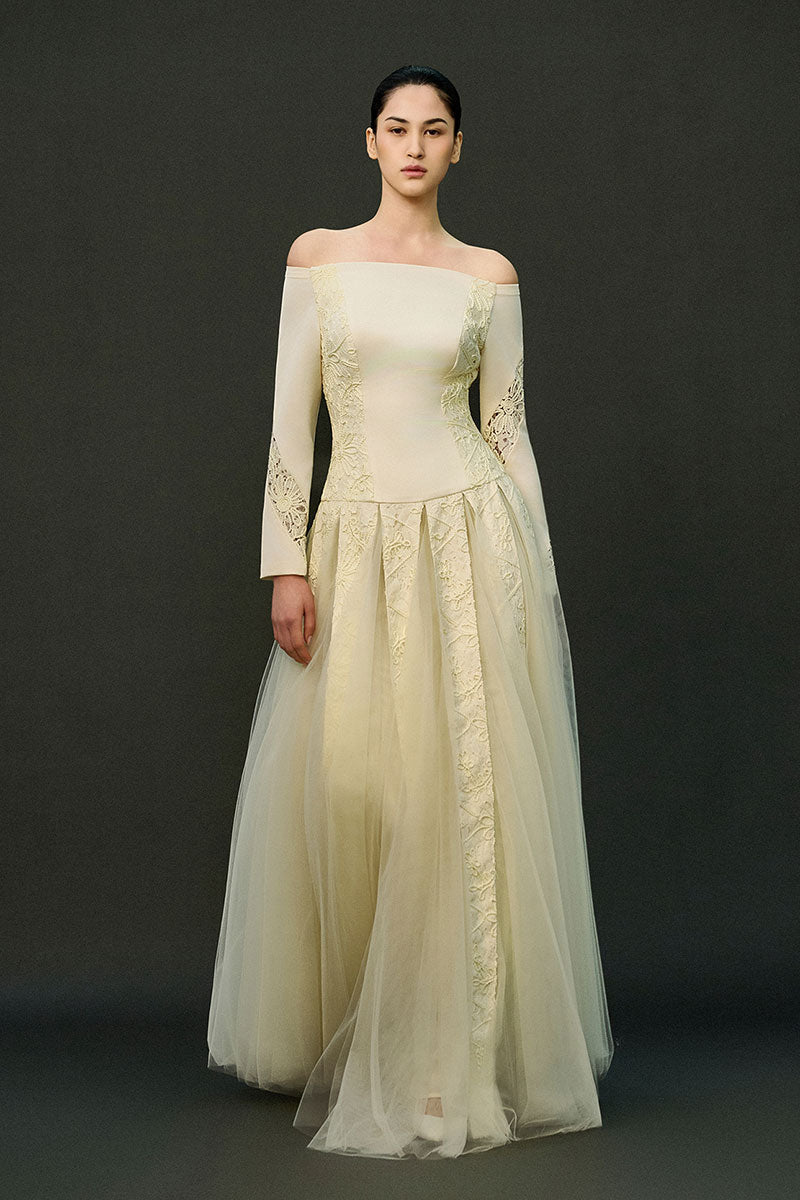 Off-white ELIRA gown by EEGEN STUDIO with elegant flowing fabric and intricate detailing, perfect for formal occasions.