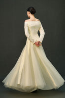 Off-white ELIRA gown by EEGEN STUDIO, featuring elegant fabric and design, perfect for formal occasions.