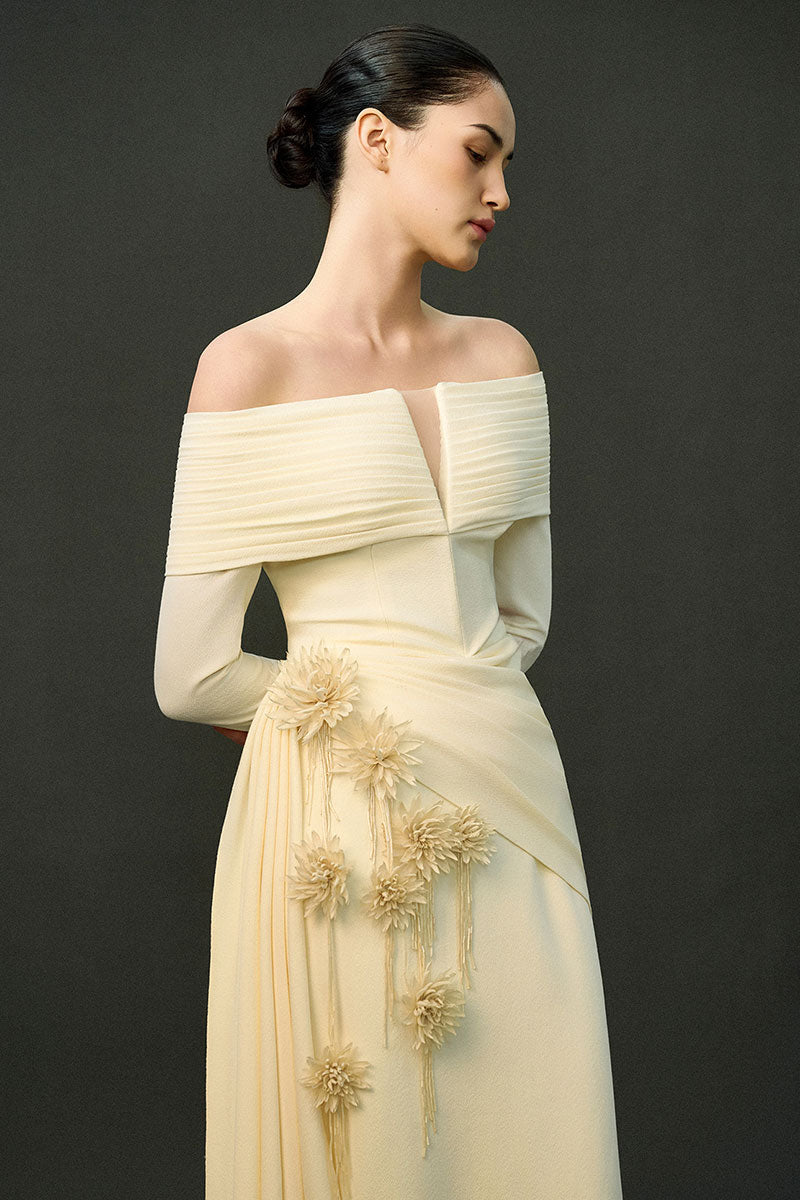 Off-white Amira gown by EEGEN Studio featuring flowing fabric and elegant design for formal occasions.