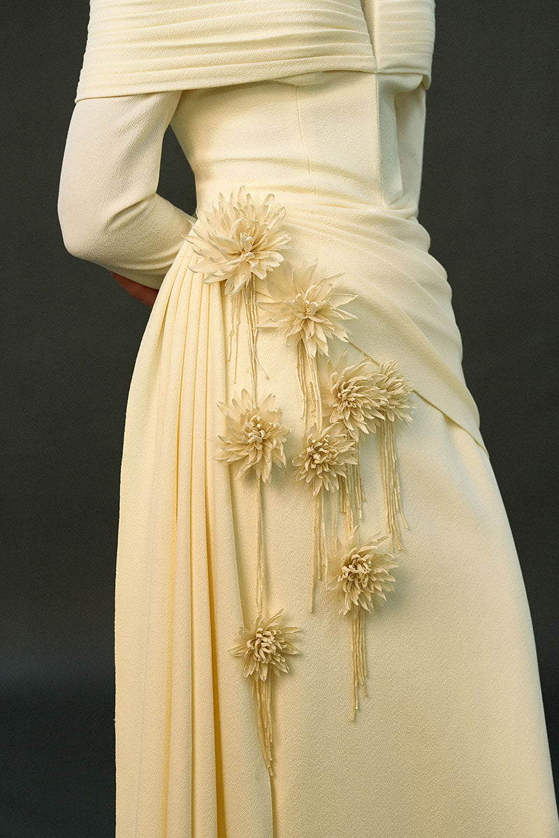 Off-white Amira gown by Eegen Studio, elegant floor-length dress with flowing fabric and intricate detailing.