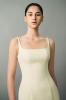 Off-white Nayla gown by EeGen Studio, elegant dress with flowing fabric, perfect for formal occasions or evening wear.