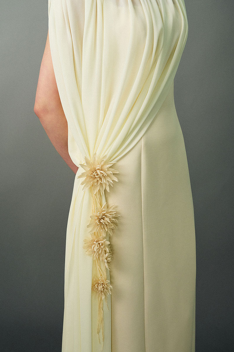 Off-white Nayla gown by EEGEN STUDIO featuring elegant design and flowing fabric, displayed on a mannequin.
