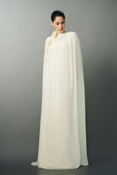 Off-white NAYLA gown by EEGEN STUDIO featuring elegant fabric and flowing design, perfect for formal occasions.