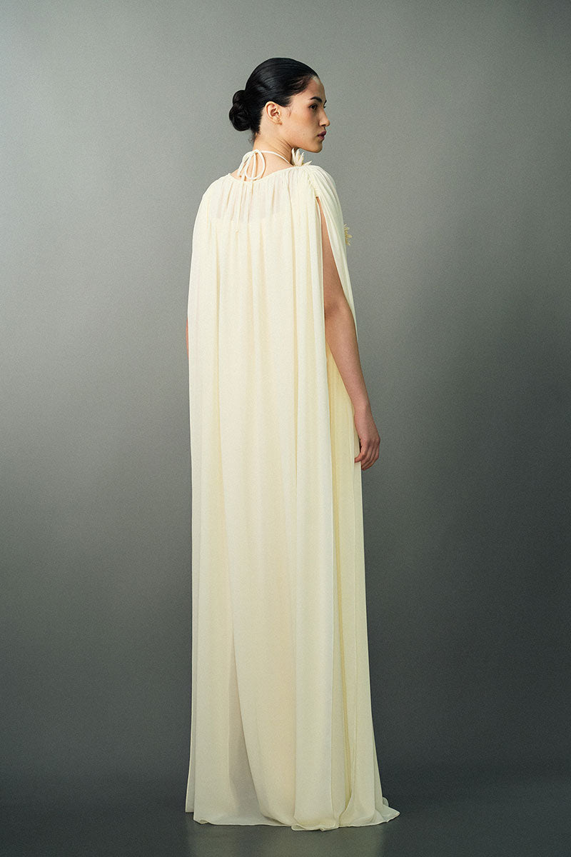 Off-white NAYLA gown by EEGEN STUDIO, featuring elegant fabric and detailed design, displayed on a mannequin.