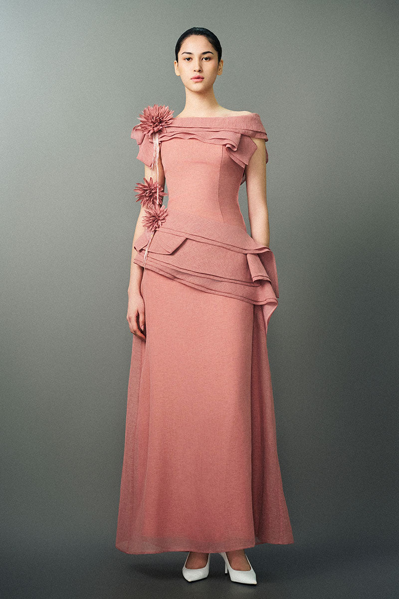 Pink RANYA dress gown by EEGEN STUDIO displayed on a hanger, showcasing elegant fabric and detailed design.