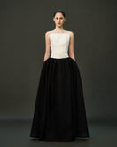 Black LINNEA gown by EEGEN STUDIO displayed on a model, featuring elegant fabric and classic design.