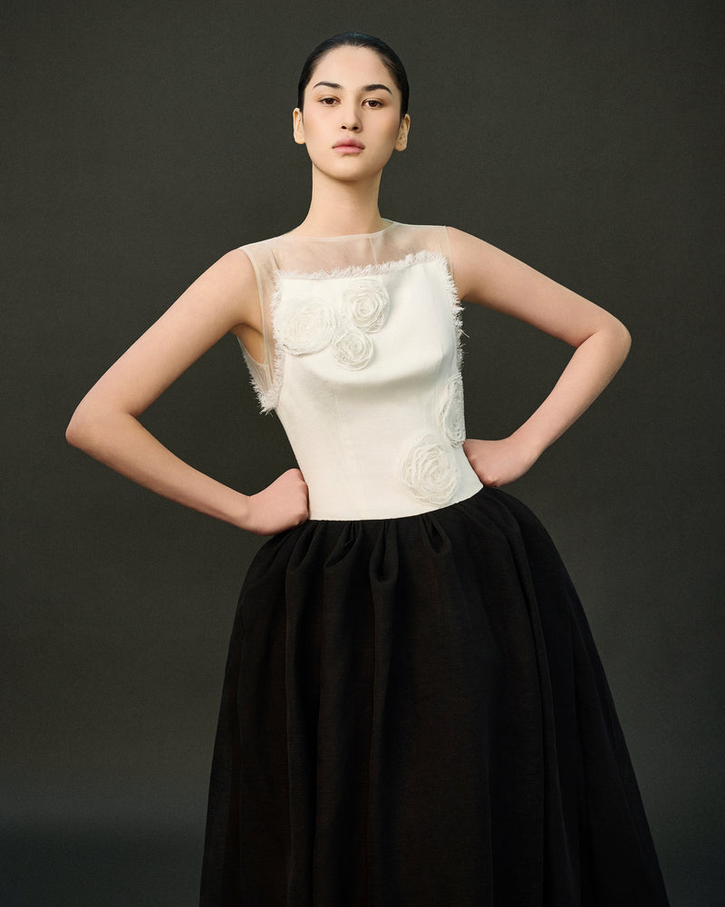Elegant black LINNEA gown by EEGEN STUDIO, showcasing smooth fabric and a flowing silhouette in a classic design.
