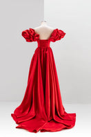 White Monetre red volume sculpted gown on mannequin, showcasing elegant design and flowing fabric for formal occasions.