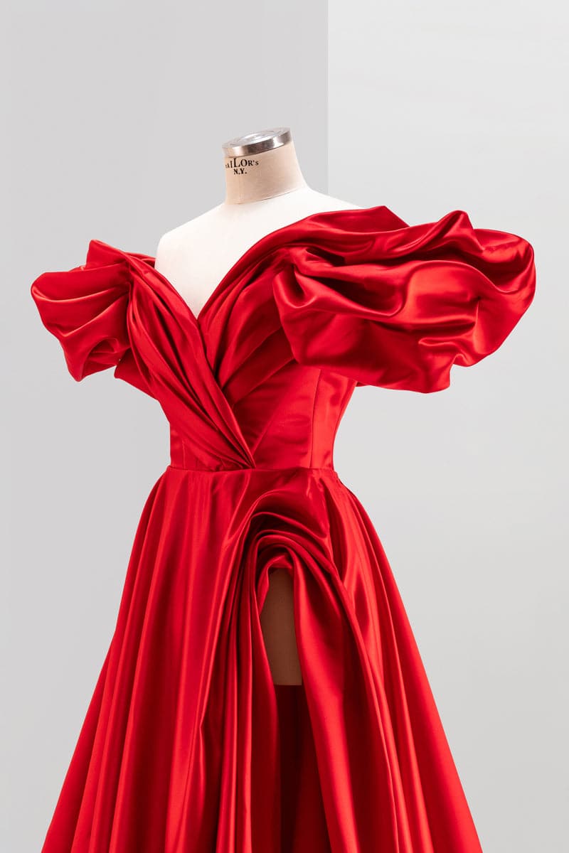 White Monetre Red Volume Sculpted Gown displayed on a mannequin, featuring elegant draping and a fitted silhouette.