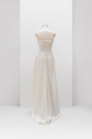 White sculptural corset gown by Monetre displayed on a mannequin, featuring intricate design and elegant silhouette.