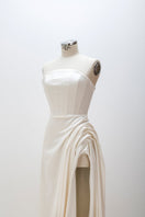 White sculptural corset gown by Monetre displayed on a mannequin, showcasing elegant structured design and intricate detailing.