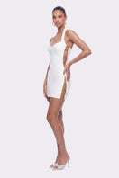 White Sabina mini dress by Nana Jacqueline featuring ring cutout details, styled for a modern, chic look.
