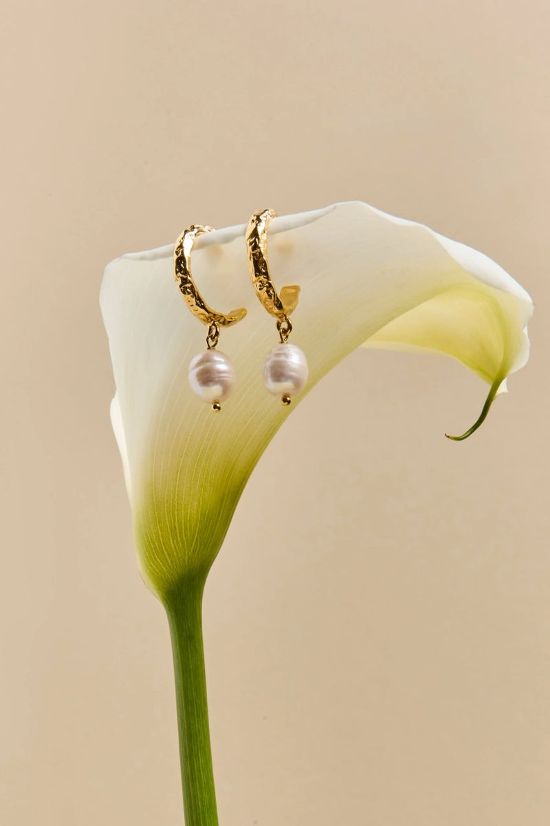 LAVANI JEWELS Sadie Pearl Earrings featuring elegant pearl dangles with gold accents on a white background.