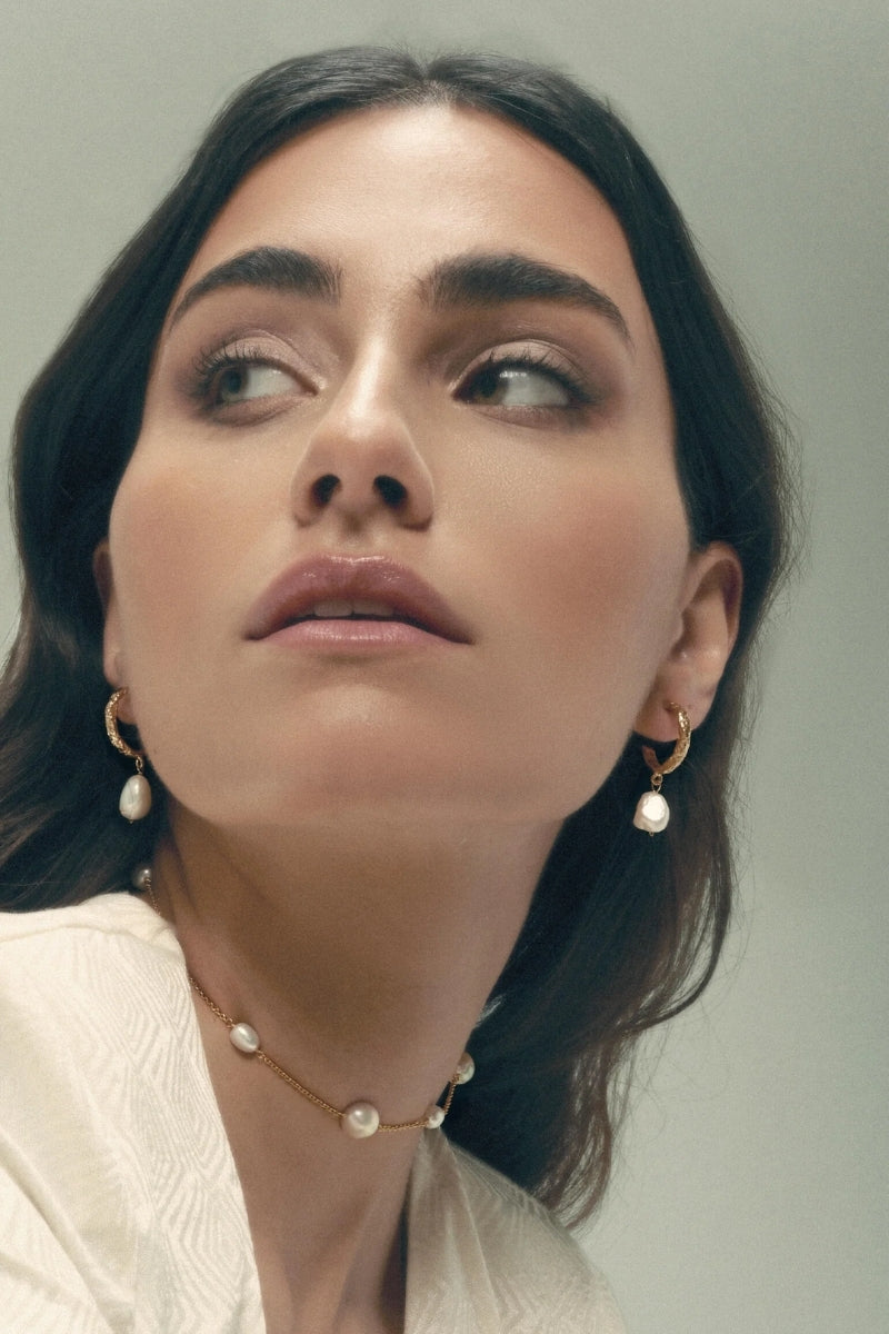 Elegant Sadie Pearl Earrings by Lavani Jewels featuring lustrous pearls and delicate design on a white background.