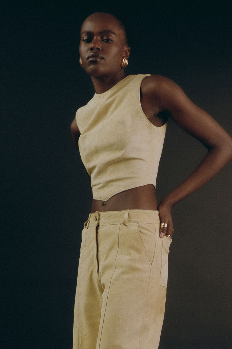 ZUT butter yellow Sam top, a stylish sleeveless blouse with a round neck, displayed on a hanger.