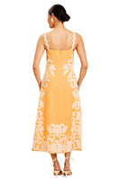 Back view of Mestiza New York Sammy embroidered midi dress in blushed citrus with intricate embroidery and flowing fabric.