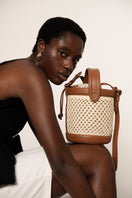 Tan ISIDORA MALVA Sandona bucket shoulder bag with a stylish, rounded design and shoulder strap.