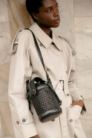 Black ISIDORA MALVA Sandona Mini Bucket shoulder bag with a sleek design and top handle, perfect for stylish everyday use.