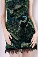 Green Saphira dress by Rayane Bacha, a stylish mini dress with a fitted silhouette and elegant design.