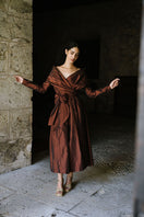 Elegant mahogany midi dress by ANA + MARIA, featuring a stylish design, showcased in a professional campaign photo.