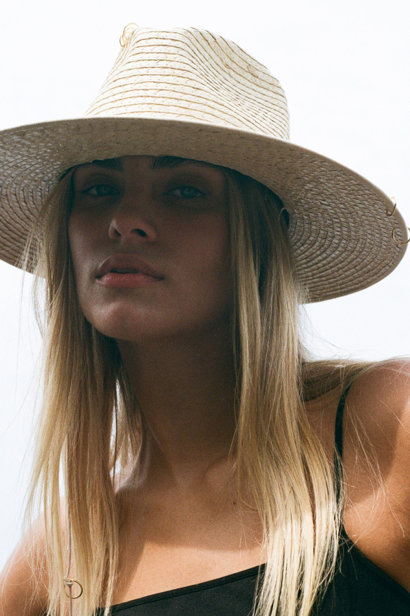 Light-colored seashell fedora hat by LE SH KA featuring a wide brim and stylish design for casual or beachwear.