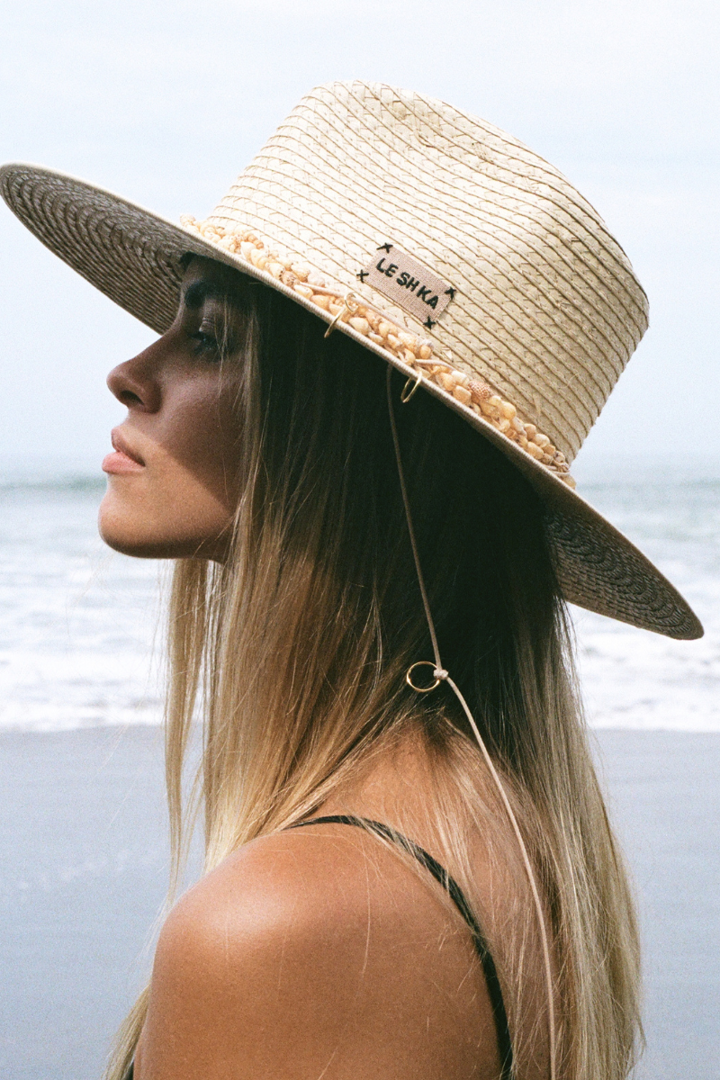 Leather fedora hat with seashell accents by LE SH KA, featuring a stylish design perfect for fashionable sun protection.
