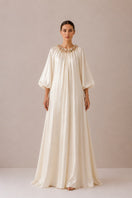 Nihan Peker Sedef vanilla gown with elegant flowing fabric and fitted waist, perfect for formal occasions.