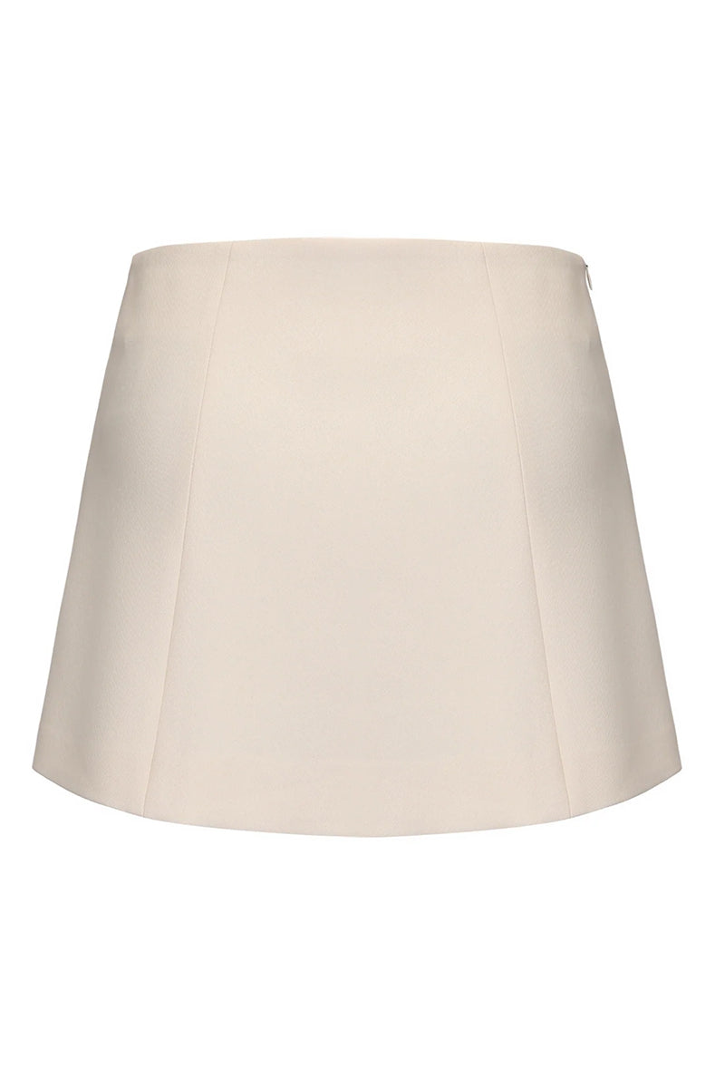 White Selena mini skirt by Nana Jacqueline, back view showing fitted waist and stylish A-line silhouette.