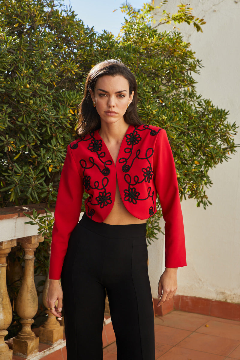 Red Señorita Rosalia jacket with stylish design, shown on a model, featuring a fitted silhouette and trendy details.