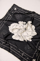 Black Señorita Luisa scarf displayed flat, showcasing its soft fabric and elegant design in a stylish accessory shot.