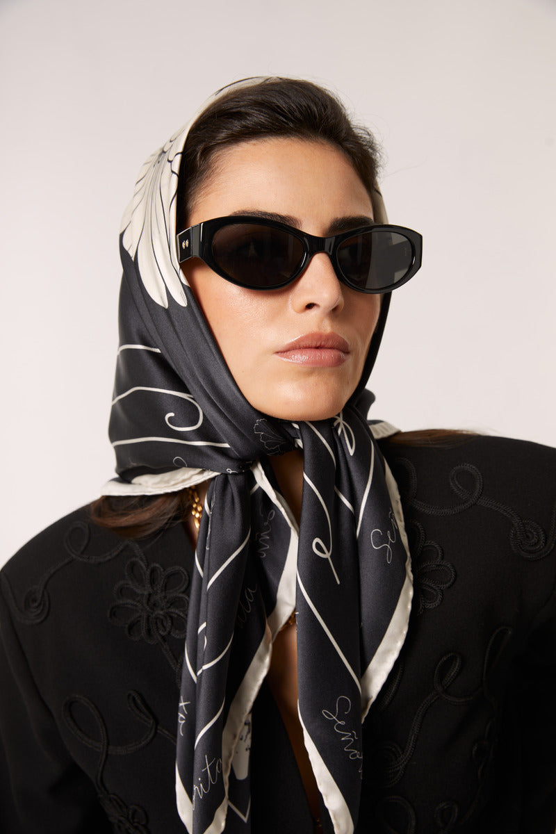 Black Señorita Luisa scarf featuring soft fabric and stylish design, perfect for adding elegance to any outfit.