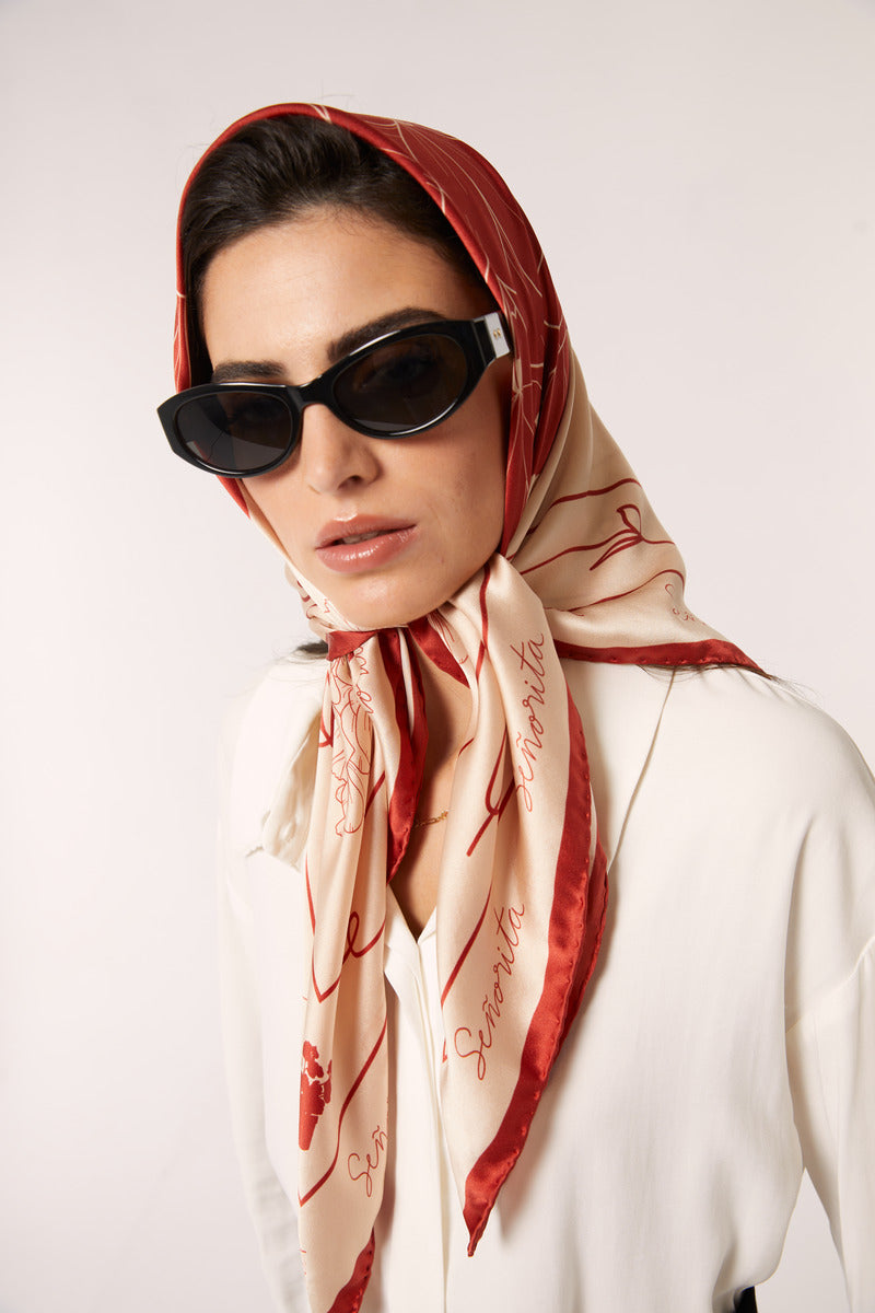 Red Señorita Luisa scarf featuring soft fabric and stylish design, perfect for adding a pop of color to any outfit.