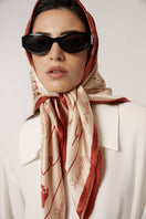 Red Señorita Luisa scarf displayed with soft fabric and elegant draping, perfect for stylish accessories and layering.