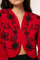 Red Señorita Rosalía jacket, stylish outerwear with a tailored fit, featuring a sleek design and vibrant color.