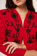 Red Señorita Rosalia jacket with a stylish cut, shown on a model with a modern urban background.