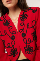 Red Señorita Rosalía jacket with a stylish, tailored fit, featuring a sleek collar and front zipper detail.