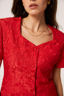 Red Señorita Aurora top featuring a stylish design, displayed on a mannequin with close-up details of the fabric and fit.