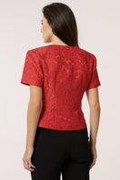Red Señorita Aurora top, stylish women's blouse with a flattering fit, shown on a model in a fashion photoshoot.