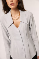 Gray Alba blouse from Señorita, stylish shirt with a relaxed fit, shown hanging on a wooden hanger.
