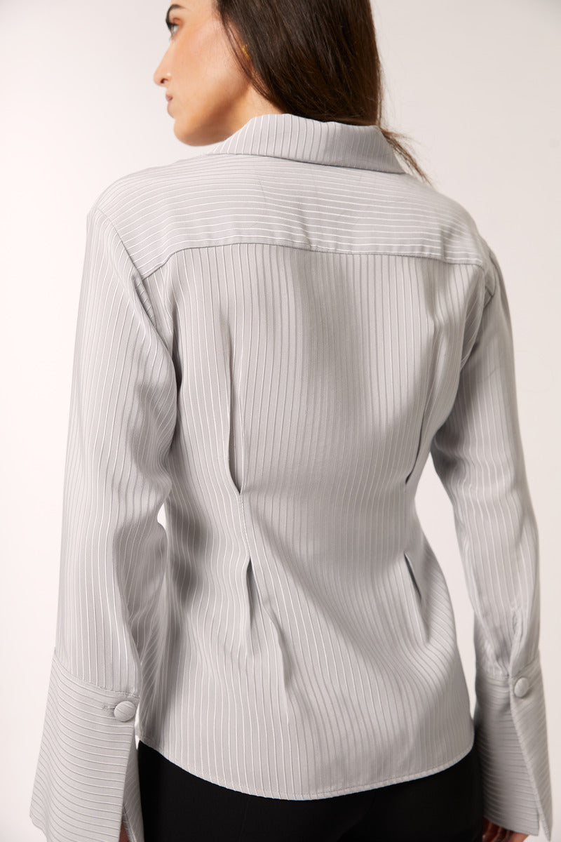 Señorita Alba gray blouse, stylish shirt with a relaxed fit, displayed on a hanger with soft fabric texture visible.
