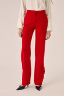 Red Señorita Teresa Pants laid flat, showing the high-waisted design and relaxed fit, perfect for casual or stylish outfits.