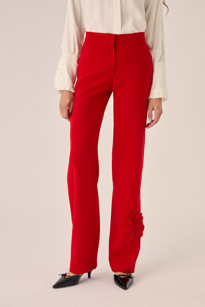 Red Señorita Teresa Pants laid flat, showing the high-waisted design and relaxed fit, perfect for casual or stylish outfits.