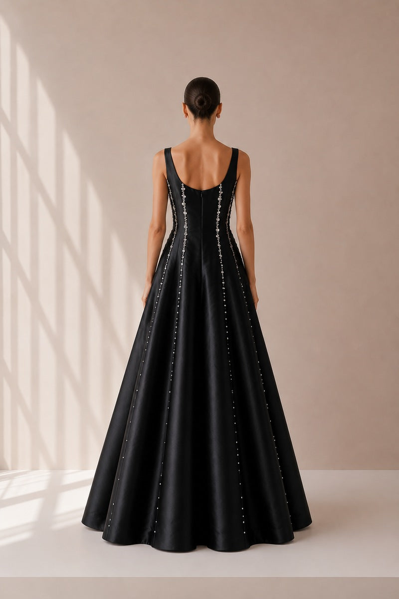 Black Seraphine gown by Nihan Peker with elegant flowing fabric and detailed design, perfect for formal occasions.