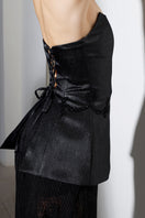 Black Seren corset and lace co-ord set by Rayane Bacha featuring intricate lace details and a fitted silhouette.