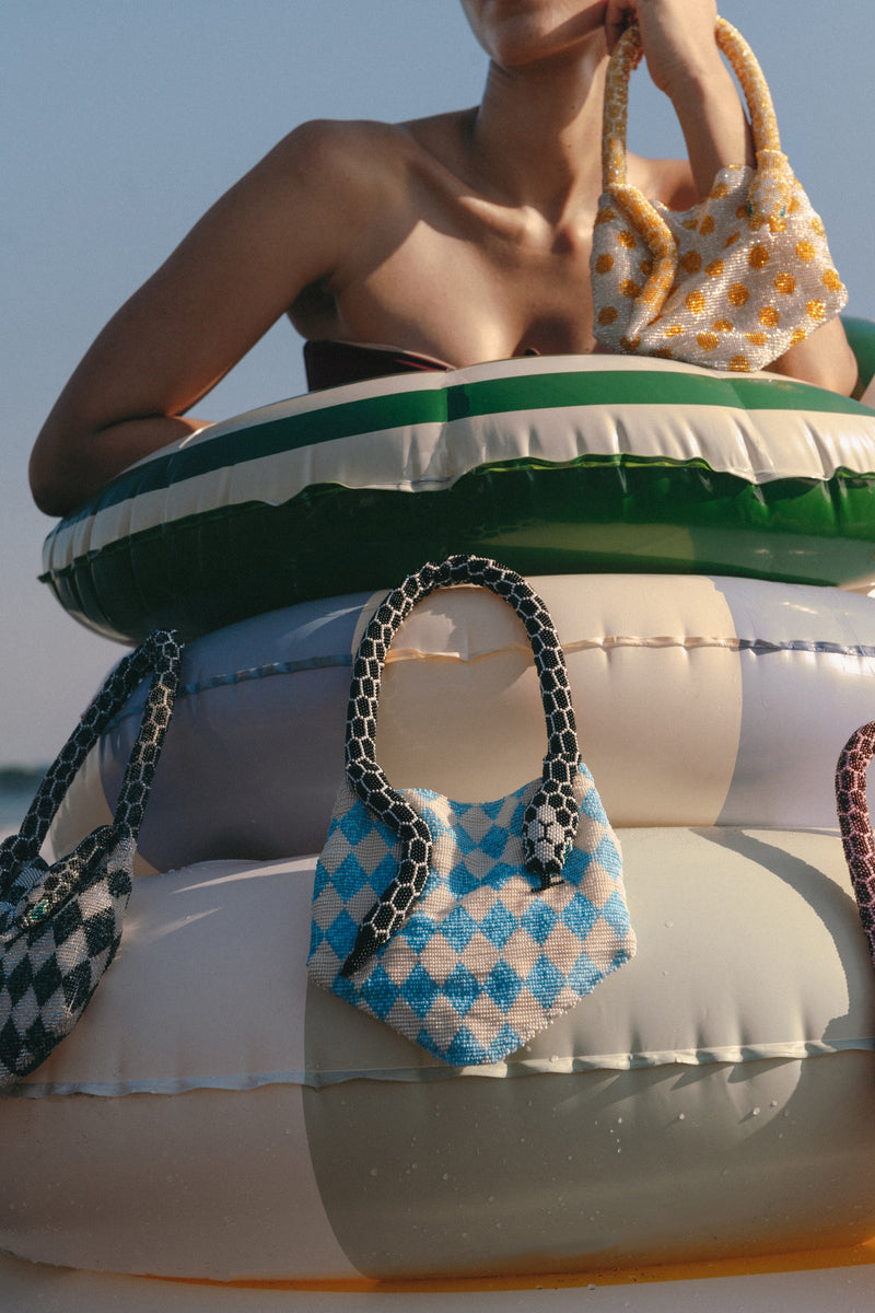 Blue and cream Serpent Mini shoulder bag by SAC DE SOUL with a sleek, stylish design and subtle snake pattern.
