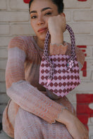 Pink SAC DE SOUL Serpent Mini shoulder bag with a sleek design and textured snake pattern, stylish accessory for everyday use.