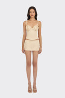 Beige shell bustier top by Stolen Stores, featuring a fitted style with shell detailing and adjustable straps.